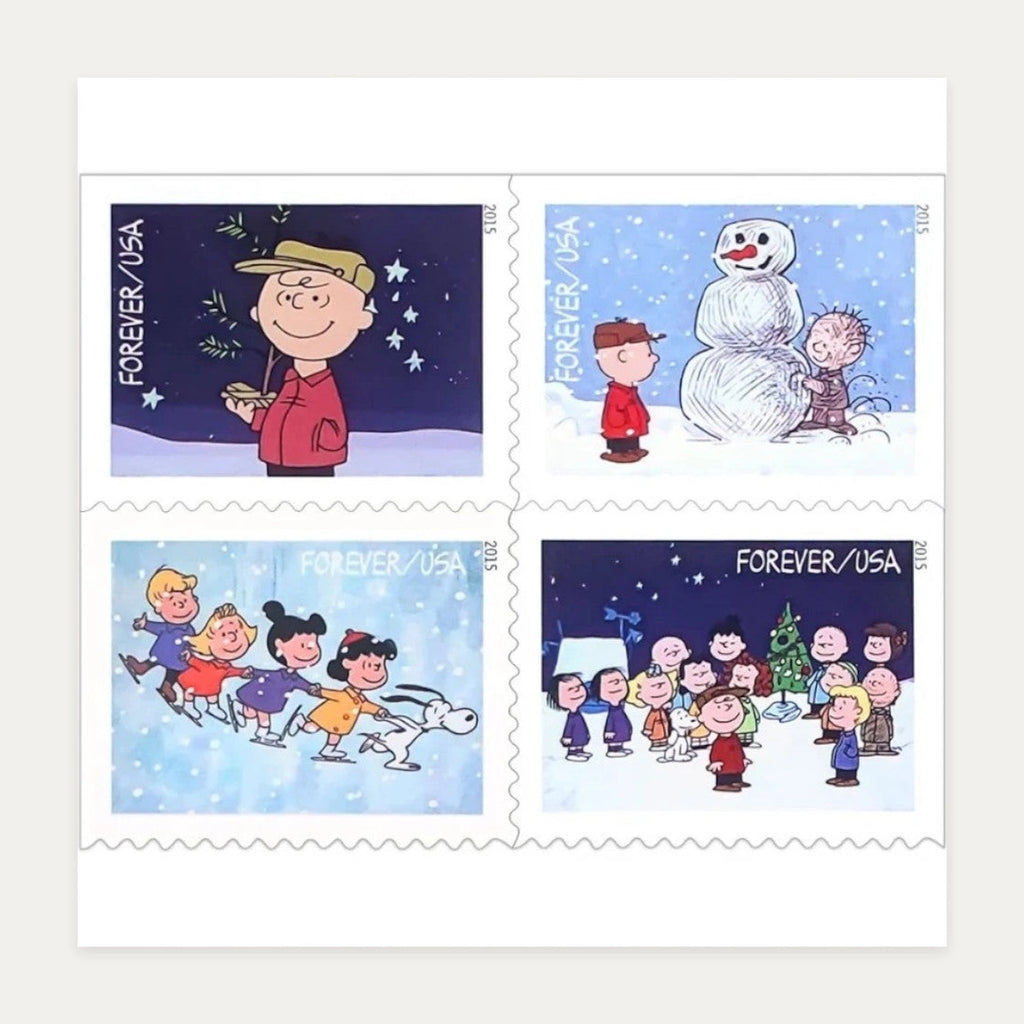 Four 2015 A Charlie Brown Christmas Forever stamp designs featuring Charlie Brown, Snoopy and the Peanuts gang