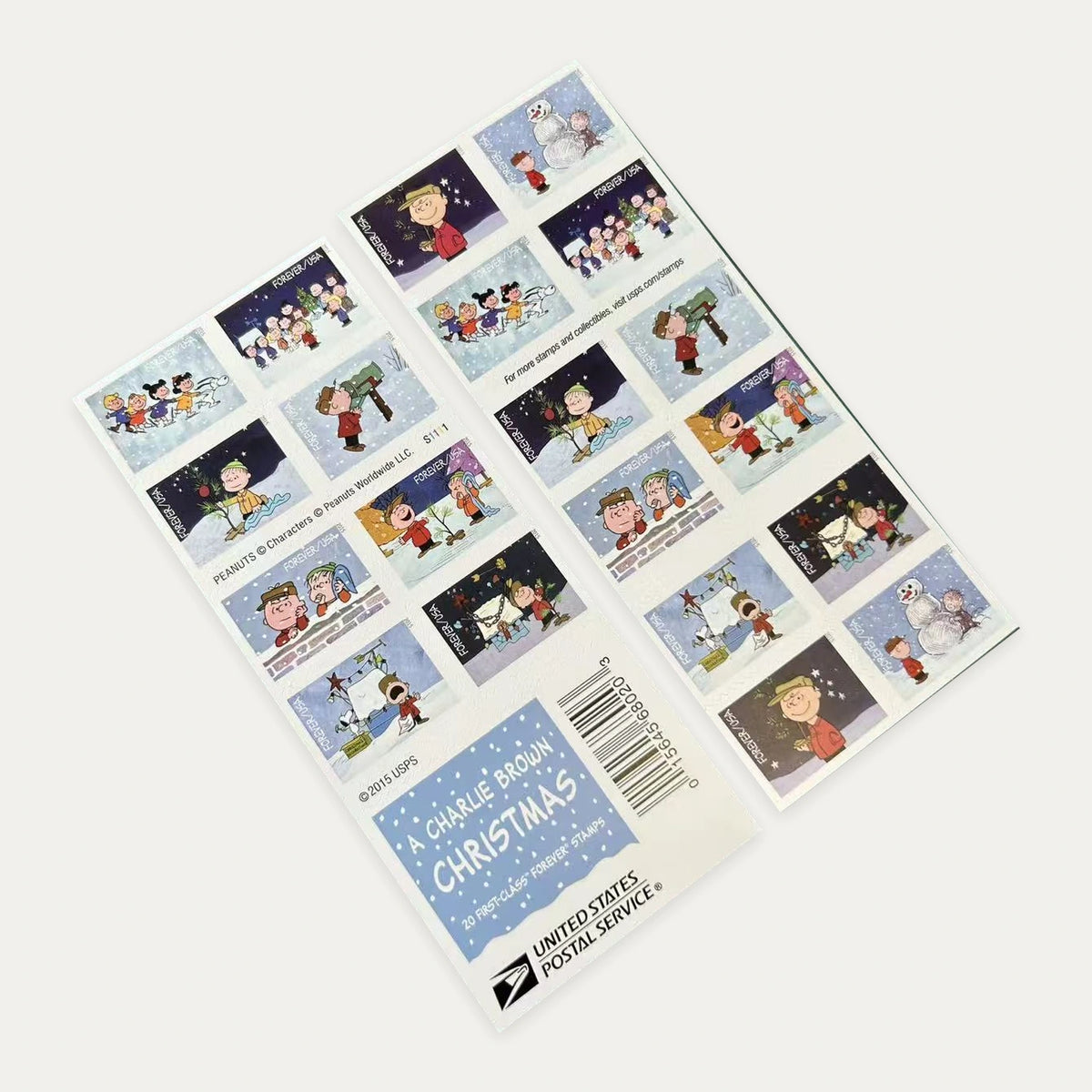 Photograph of a A Charlie Brown Christmas Forever stamp booklet showing both sides and the booklet cover